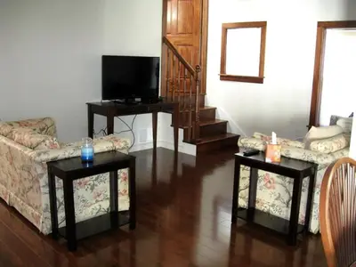 a living room with a couch and two tables at Unique Renovated Barn Rental with Pond near Cooperstown, New York in Fly Creek
