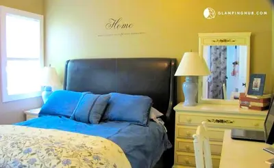 a bedroom with a bed and a dresser and a mirror at Charming Waterfront Cottage Rental near Topsmead State Forest, Connecticut in Harwinton