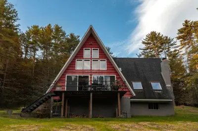 a house with a gambrel roof with a balcony at Stunning A-Frame Cabin Rental in the Catskills near Albany, New York in Kingston