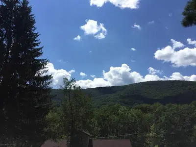 a view of a mountain with a blue sky and clouds at Rustic Couples' Cabin for Idyllic Catskills Getaway, Upstate New York in Shandaken