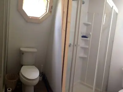a small bathroom with a toilet and a mirror at Rustic Couples' Cabin for Idyllic Catskills Getaway, Upstate New York in Shandaken