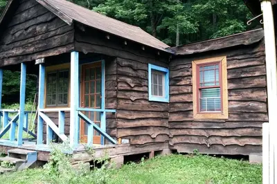a log cabin with windows and a porch at Rustic Couples' Cabin for Idyllic Catskills Getaway, Upstate New York in Shandaken
