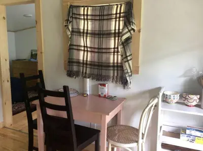 a kitchen with a table and chairs and a curtain at Rustic Couples' Cabin for Idyllic Catskills Getaway, Upstate New York in Shandaken