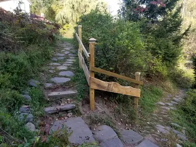 a wooden fence on the side of a path at Superb Family Cabin with Mountain Views and Deck in Shandaken, New York in Shandaken