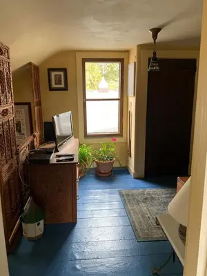 an office with a desk and a window and a door at Luxurious Riverfront Cottage with a Hot Tub and a Fireplace near the Twin Lakes, Connecticut in Canaan
