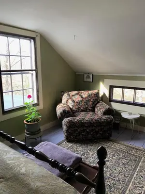 a living room with a couch and a chair at Luxurious Riverfront Cottage with a Hot Tub and a Fireplace near the Twin Lakes, Connecticut in Canaan