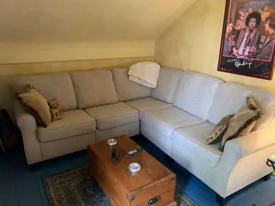 a living room with a couch and a coffee table at Luxurious Riverfront Cottage with a Hot Tub and a Fireplace near the Twin Lakes, Connecticut in Canaan