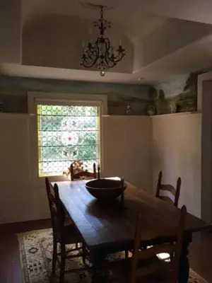 a dining room with a wooden table with chairs and a window at Luxurious Riverfront Cottage with a Hot Tub and a Fireplace near the Twin Lakes, Connecticut in Canaan