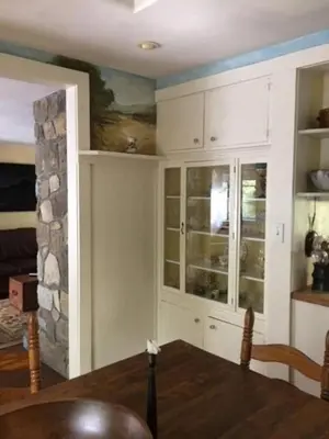 a kitchen with white cabinets and a wooden table at Luxurious Riverfront Cottage with a Hot Tub and a Fireplace near the Twin Lakes, Connecticut in Canaan
