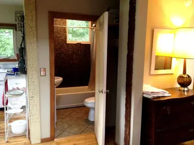 a bathroom with a tub and a toilet and a sink at Romantic Mountain Cabin with Stunning Views in Ulster County, New York in Shandaken