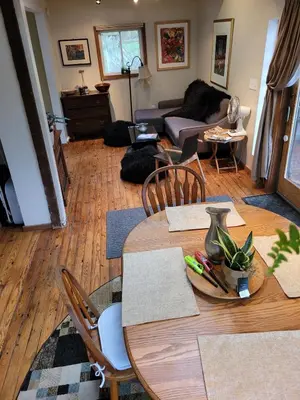a living room with a table and a couch at Romantic Mountain Cabin with Stunning Views in Ulster County, New York in Shandaken