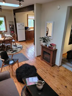 a living room with a couch and a table at Romantic Mountain Cabin with Stunning Views in Ulster County, New York in Shandaken