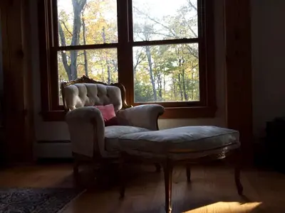 a living room with a chair and a window at Modern and Family-Friendly Vacation Rental in the Berkshires near Great Barrington in Monterey