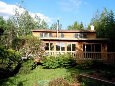 a large wooden house with a yard at Family-Friendly Cabin in the Deerfield Valley of Mount Snow, West Dover Vermont in West Dover