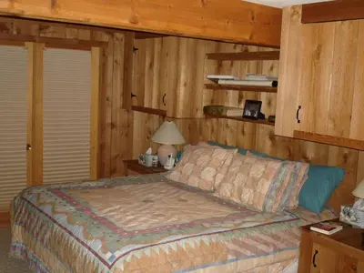 a bedroom with a bed and wooden walls at Family-Friendly Cabin in the Deerfield Valley of Mount Snow, West Dover Vermont in West Dover
