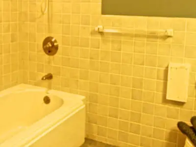 a bathroom with a white tub and a sink at Delightful Vacation Rental with a Private Dock on Candlewood Lake in Connecticut in New Milford