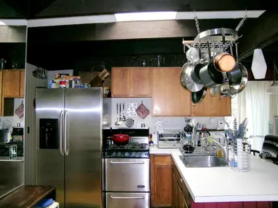 a kitchen with a stainless steel refrigerator and a sink at Delightful Vacation Rental with a Private Dock on Candlewood Lake in Connecticut in New Milford