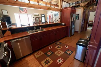 a kitchen with a sink and a refrigerator at Gorgeous Green Mountains Vacation Rental with a Pool in Manchester, Vermont in Manchester Center
