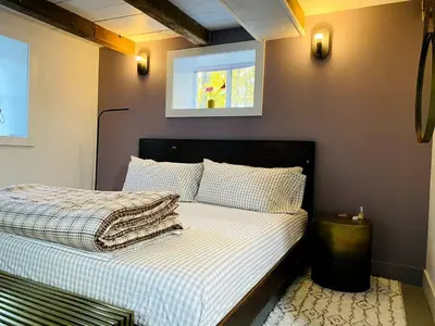 a bedroom with a bed with a window and a bed sidx sidx sidx at Modern Cottage Perfect for Glamping in New York State in Accord