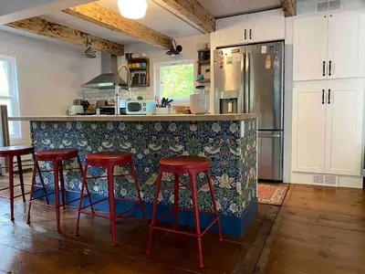 a kitchen with a counter with red bar stools at Modern Cottage Perfect for Glamping in New York State in Accord