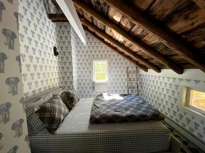 a bedroom with a bed in the corner of a room at Modern Cottage Perfect for Glamping in New York State in Accord