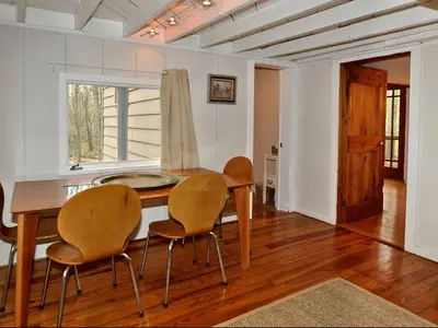 a dining room with a table and four chairs at Idyllic Getaway Cottage in the Woods near Woodstock, New York in Woodstock