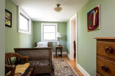 a living room with green walls and a chair at Secluded Cottage Rental with a Fireplace in Greenville, New York in Greenville