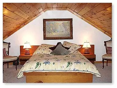a bedroom with a bed with two lamps and two chairs at Gorgeous Getaway Suite in a Converted Barn near Hudson, New York in Hudson