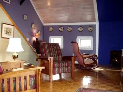 a living room with a couch and a chair at Gorgeous Getaway Suite in a Converted Barn near Hudson, New York in Hudson