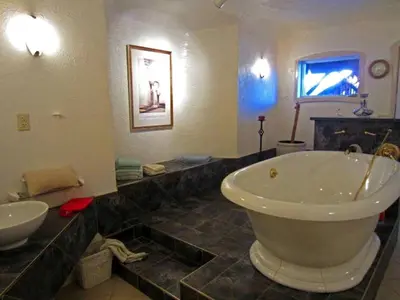 a bathroom with a large tub and a sink at Pet-Friendly Vacation Rental on a Working Farm near Hudson, New York in Hudson