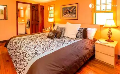 a bedroom with a large bed in a room at Peaceful Getaway above a Beautiful Yoga Studio near Devil's Den Nature Preserve, Connecticut in Redding