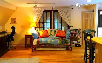 a living room with a couch and a window at Peaceful Getaway above a Beautiful Yoga Studio near Devil's Den Nature Preserve, Connecticut in Redding