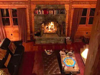 an overhead view of a living room with a fireplace at Cozy Log Cabin with a Private Hot Tub near Beartown State Forest, Massachusetts in Monterey
