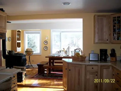 a kitchen with a large window and a table in it at Enchanting Secluded Cabin Rental near Salem, New York in Salem