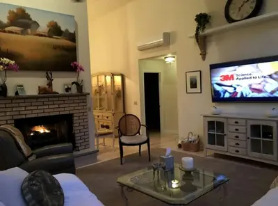 a living room with a couch and a tv at Delightful Cottage Rental with Scenic Views near the Poconos, Pennsylvania in Tobyhanna