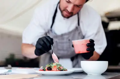a man in a kitchen preparing a plate of food at Stylish Camping Tents Set on an Organic Farm in Hudson Valley, New York State in Ghent