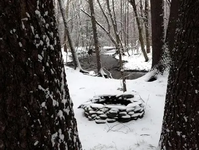 a fire pit in the snow between two trees at Romantic Year-Round Cabin Getaway with Free Wi-Fi in Saugerties, New York in Saugerties