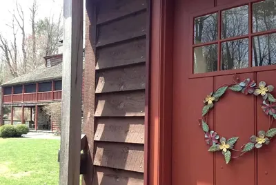 a red door with a heart shaped wreath on it at Romantic Year-Round Cabin Getaway with Free Wi-Fi in Saugerties, New York in Saugerties