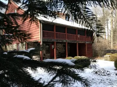 a log cabin in the winter with snow on the ground at Romantic Year-Round Cabin Getaway with Free Wi-Fi in Saugerties, New York in Saugerties