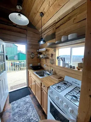 a kitchen with a stove and a sink at Lovely Farmhouse Cabin with Incredible Landscape Views in New York in Worcester