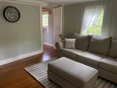 a living room with a couch and a table at The Red Country Cottage in Amenia