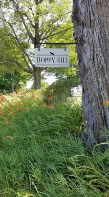 a sign that reads hyogo hill next to a tree at Hoppy Hill Farm House in Dover Plains