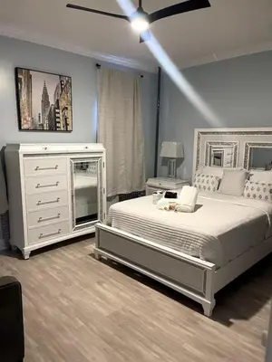 a bedroom with a large bed with a dresser and a dresser at Sweet Diamonds & Adventures 10 Mins To NYC in Union City