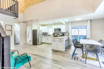 a kitchen and dining room with a table and chairs at The Hut House 3BR 3BA Game Room Massage Chair in Lake Ariel