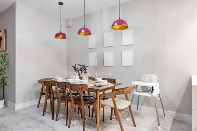 a dining room with a wooden table and chairs at Mid-Century Stay 5BR and 5 Baths w PS5 & Laundry in Brooklyn