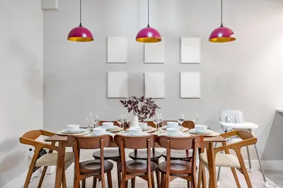 a dining room with a table and chairs at Mid-Century Stay 5BR and 5 Baths w PS5 & Laundry in Brooklyn