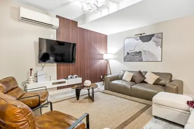 a living room with a couch and a tv at Mid-Century Stay 5BR and 5 Baths w PS5 & Laundry in Brooklyn