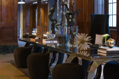 a dining room table with chairs and a glass table at Renaissance Albany Hotel in Albany