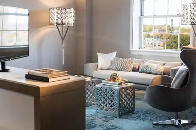 a living room with a couch and a chair at Renaissance Albany Hotel in Albany