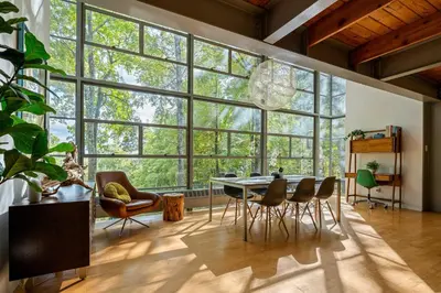 a room with a table and chairs and a large window at Epic architectural masterpiece views & hot tub in Accord